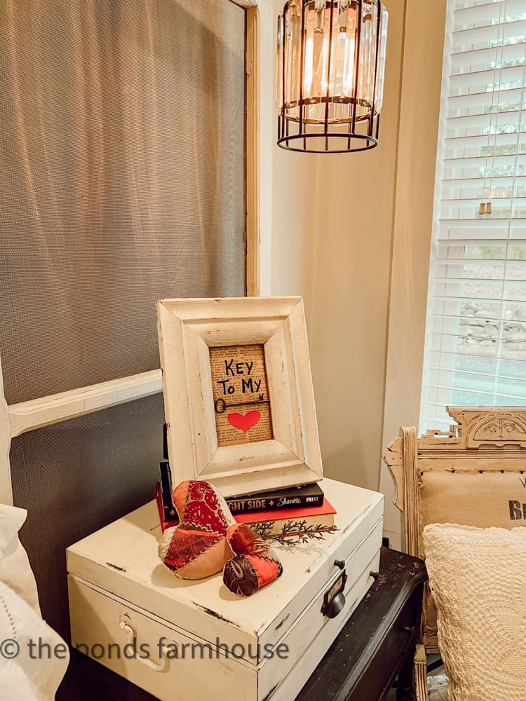 Thrift store finds and vintage quilt hearts on side table in guest bedroom for Valentine's DAy.