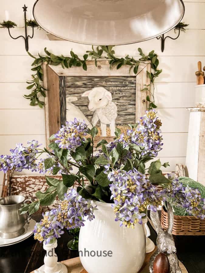 LIlac Centerpiece in ironstone vase with Mother's Love Painting draped with thistle garland.  