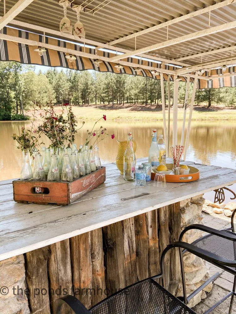 Outdoor bar by the pond.  DIY bar made with reclaimed wood and gather field rock