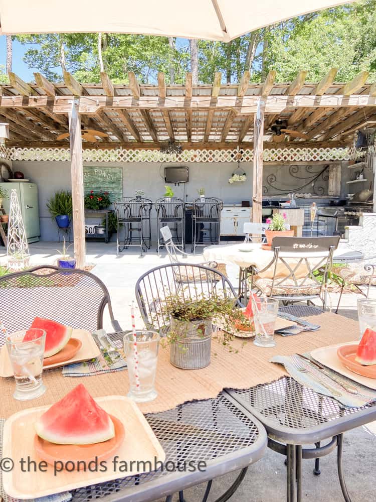 Outdoor Dining tables in front of building, decorated for summer entertaining.