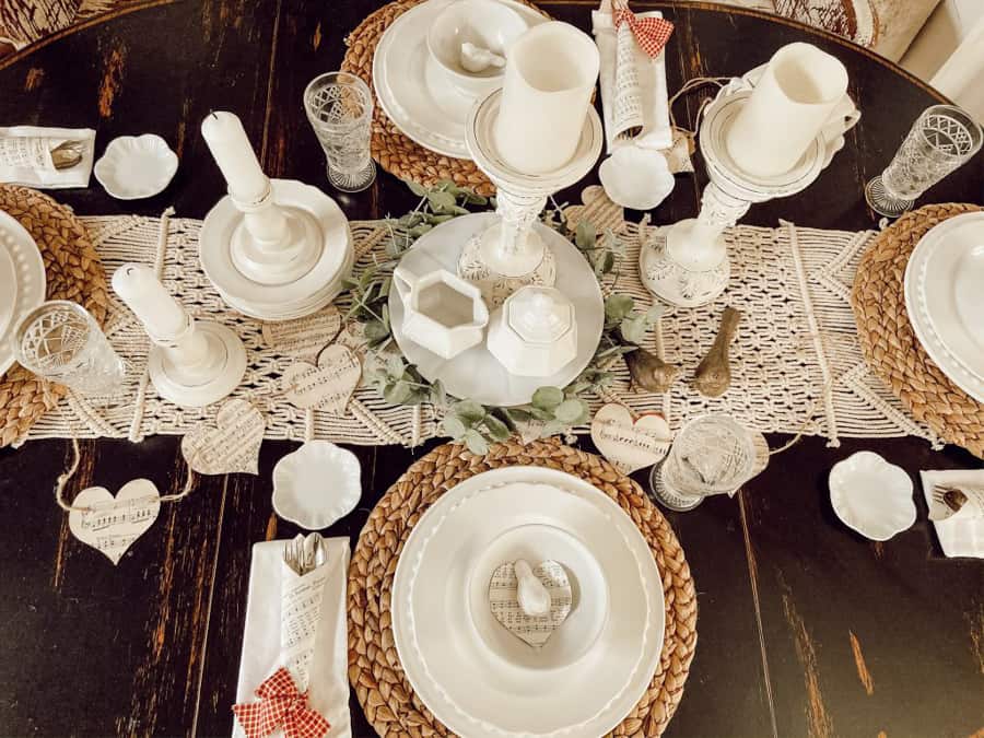 Neutral Valentine's Decor with white dishes, thrifted white candlesticks, DIY paper garlands and cutlery cones. 