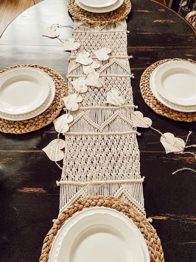 Add DIY paper heart garlands to table setting for a farmhouse style Valentine's Day Tablescape.
