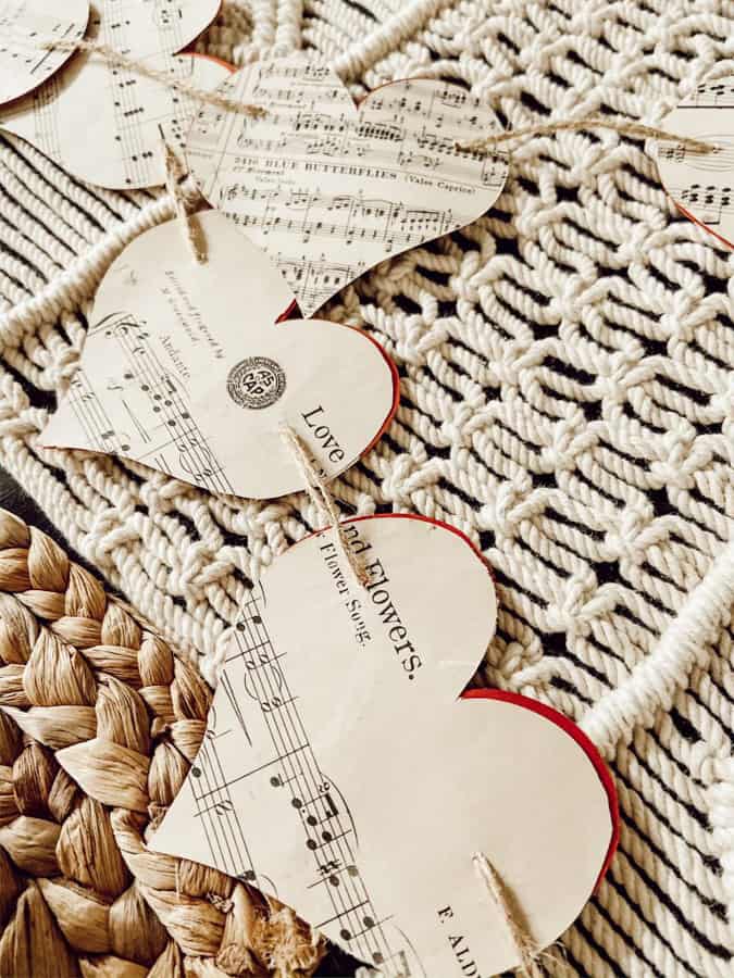 Add DIY paper hearts to table setting for a farmhouse style Valentine's Day Tablescape. Cottagecore DIY old paper hearts