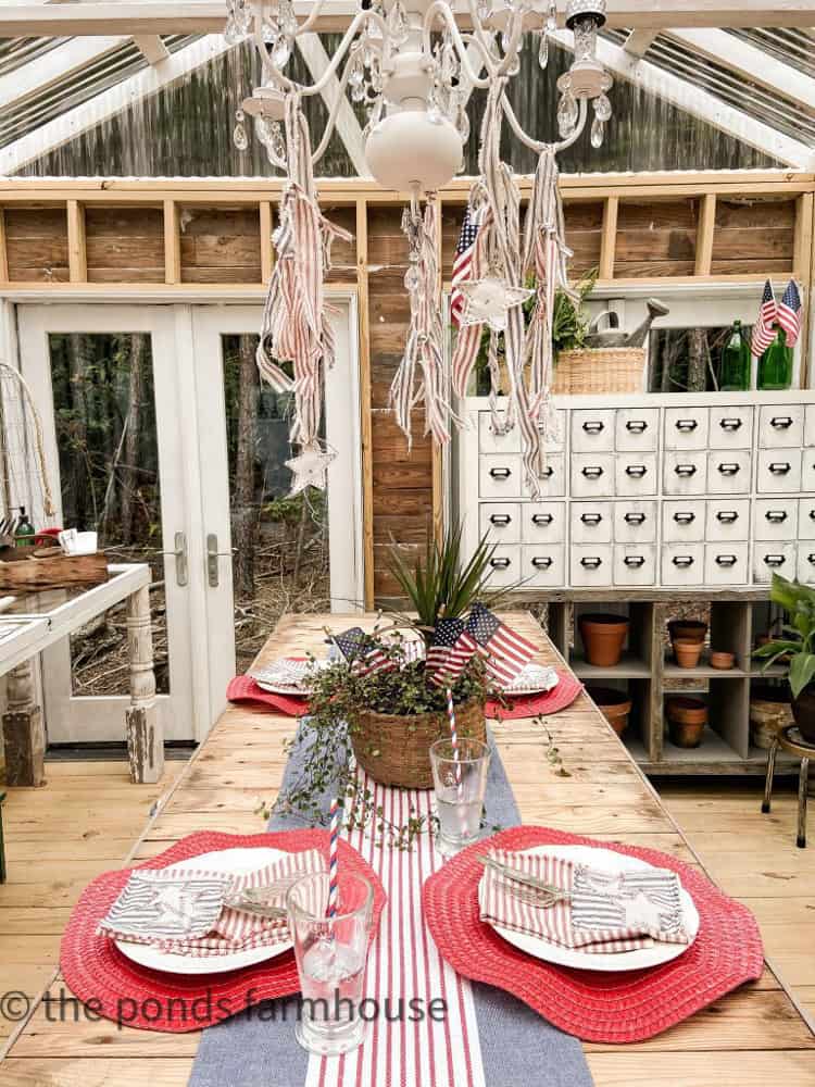 Scrap ticking fabric on greenhouse chandelier for 4th of July decorating.