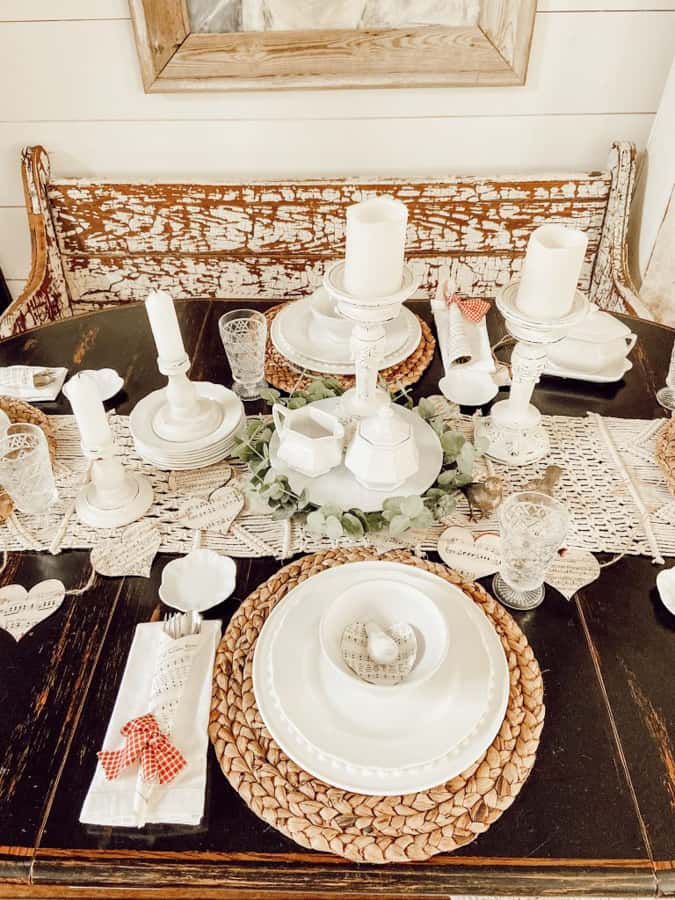 Neutral Valentine's Decor with white dishes, thrifted white candlesticks, DIY paper garlands and cutlery cones. 