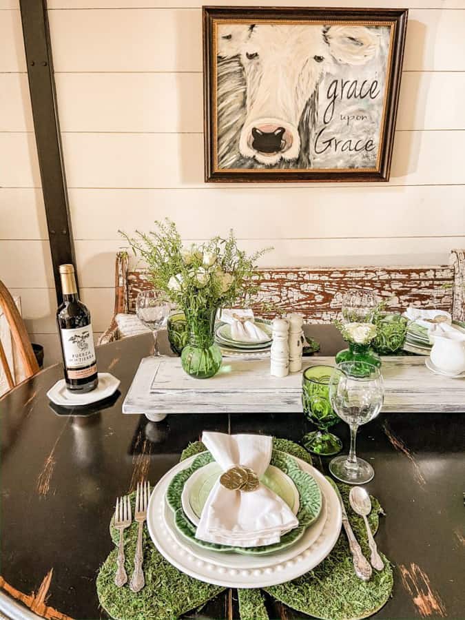 Table setting with Gold Coin napkin Ring and green and white dishes.  