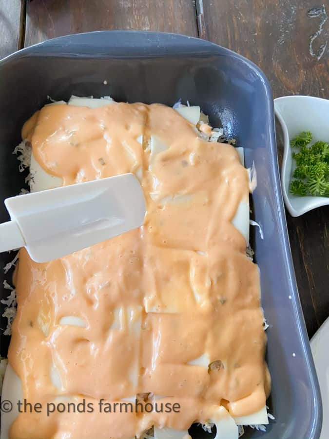 Spread thousand island salad dressing over the top of layers chicken reuben recipe.  