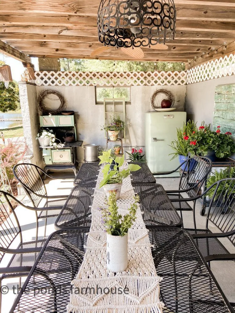 Dining Table inside the DIY outdoor kitchen with view of vintage cookstove and refrigerator.