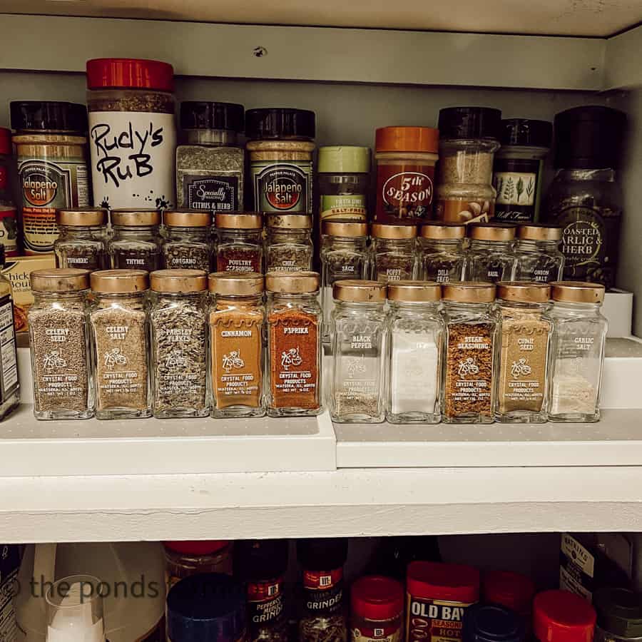 Vintage spice jars with copper lids in pantry