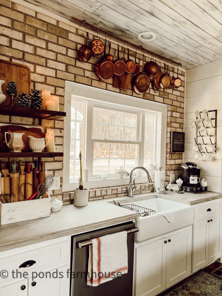 Cozy stacks of vintage copper for Winter Decoration Ideas in Farmhouse kitchen with concrete countertops