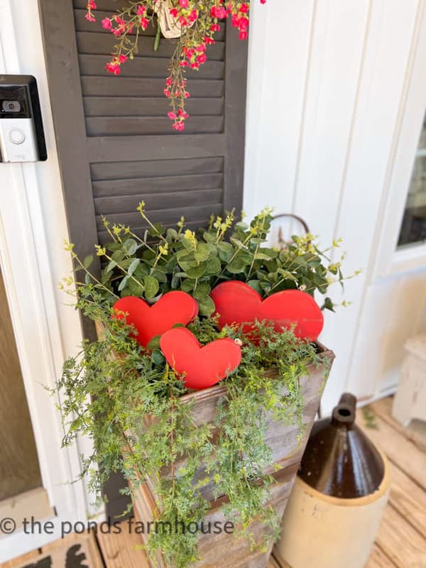 Wooden red hearts in porch planters