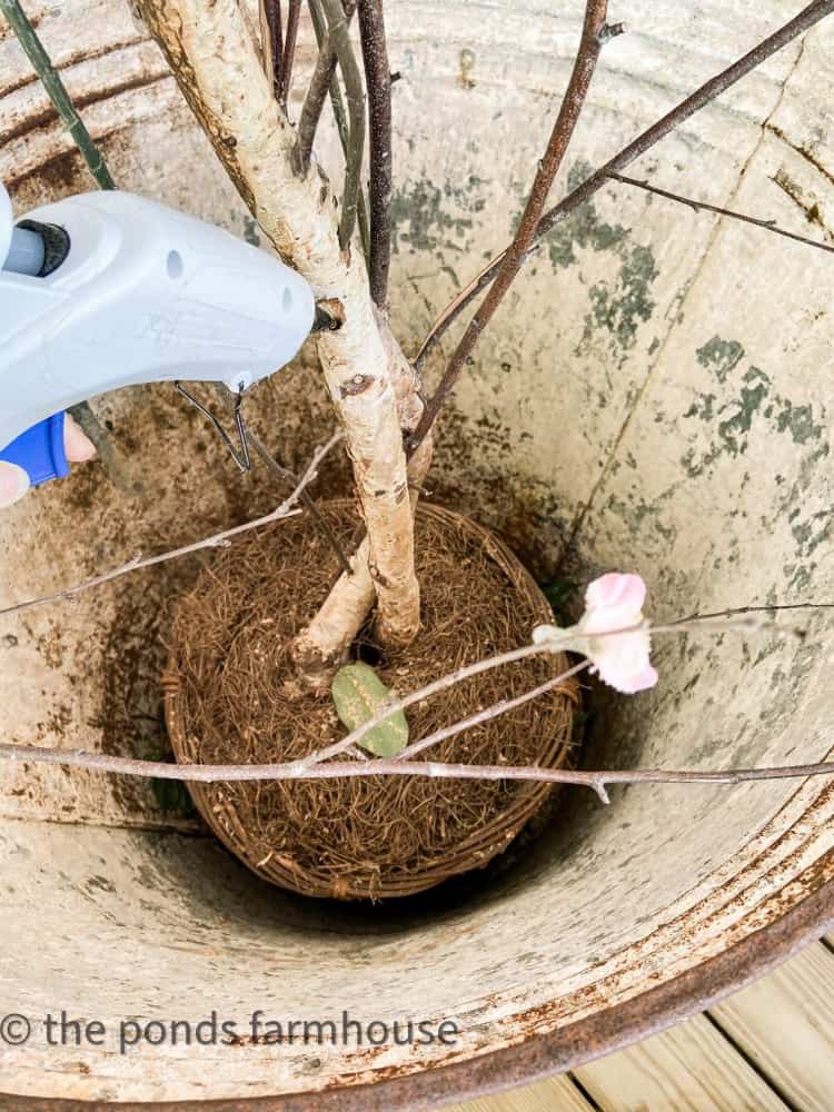 add hot glue to hold new cherry blossom stems.