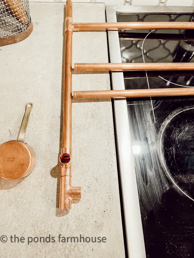 Attach copper pipes to make a Spice Rack DIY for French Farmhouse Kitchen Decor.