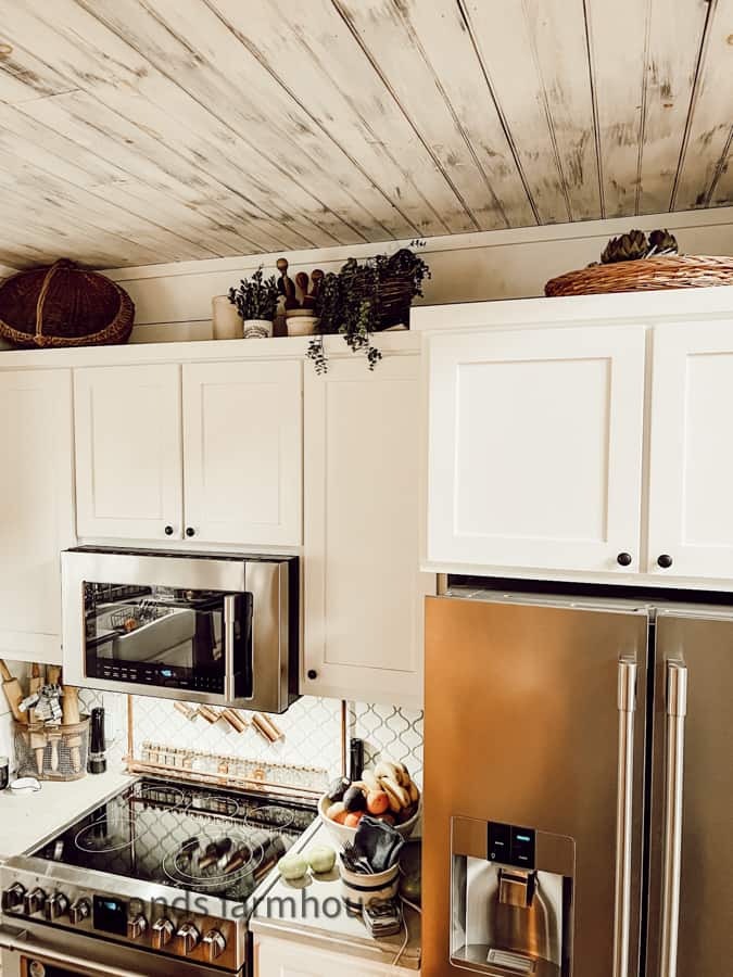 Vintage Baskets above cabinets in modern farmhouse kitchen 