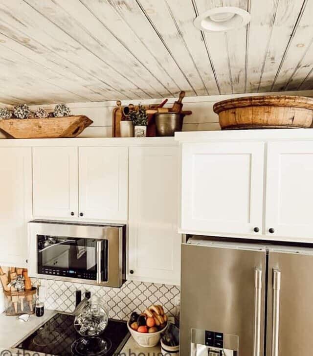 cropped-wooden-bowls-and-crocks-above-kitchen-cabinets.jpg