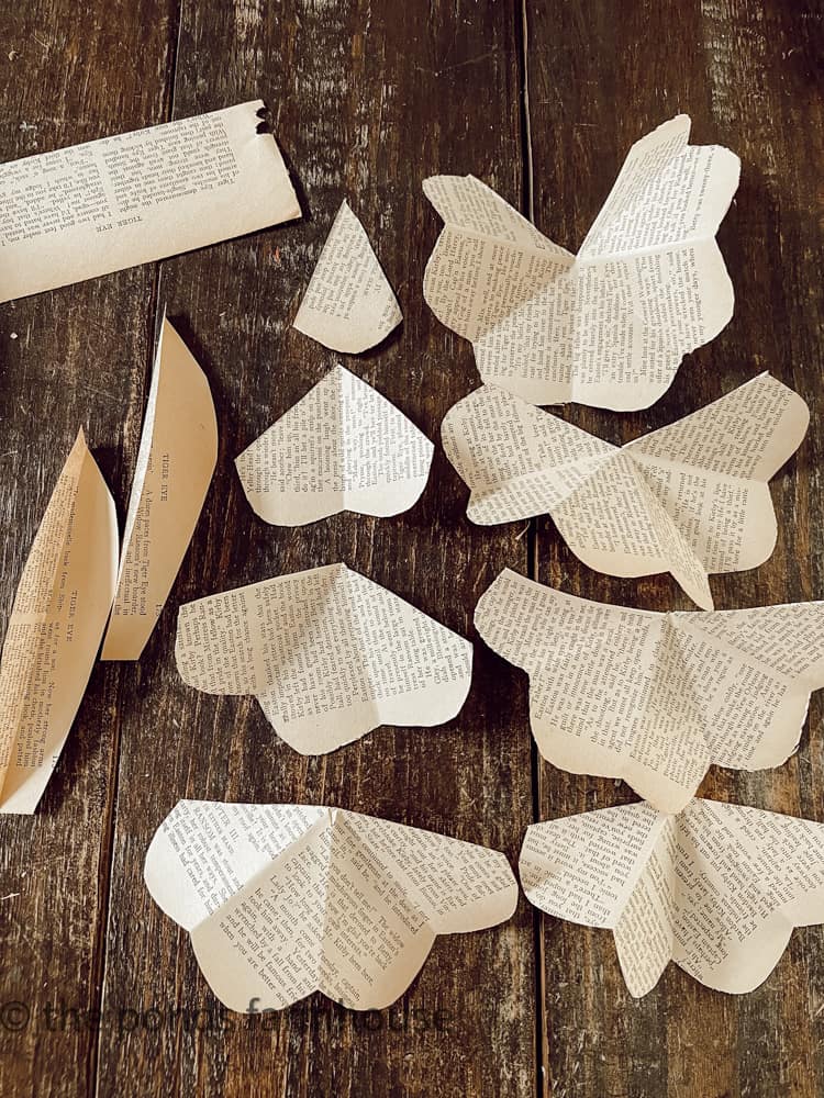 Cut old book pages to make paper flowers for DIY Valentine Wreath