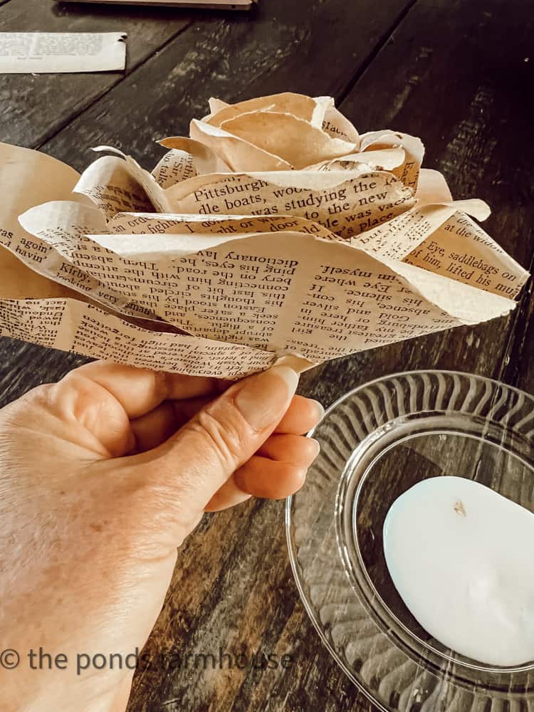 Add petals to the bottom of the paper rose 