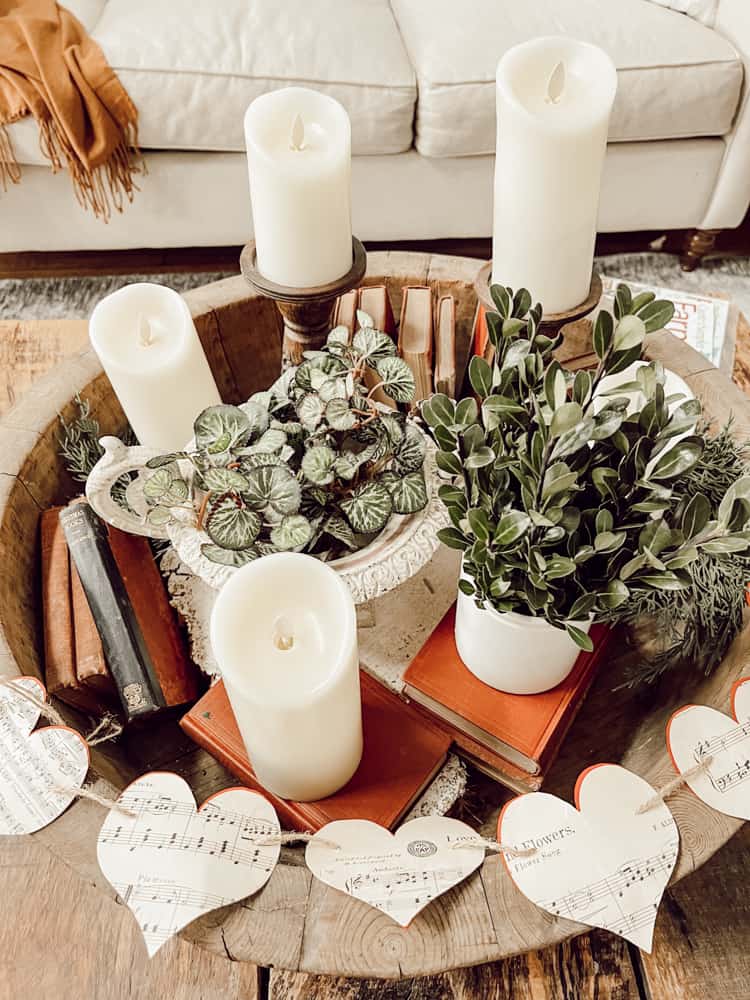 Vintage Music Page Paper Heart Garland surrounding book and candle vignette.