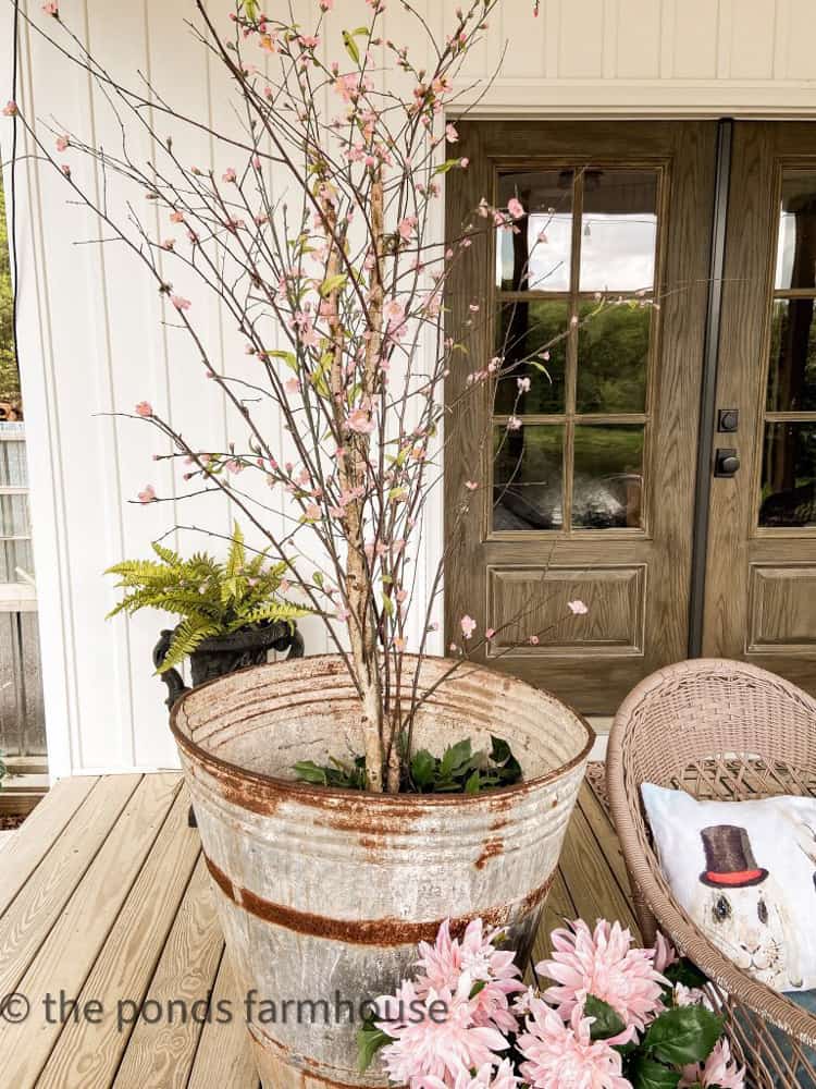 Update a faux ficus tree with cherry blossom blooms.