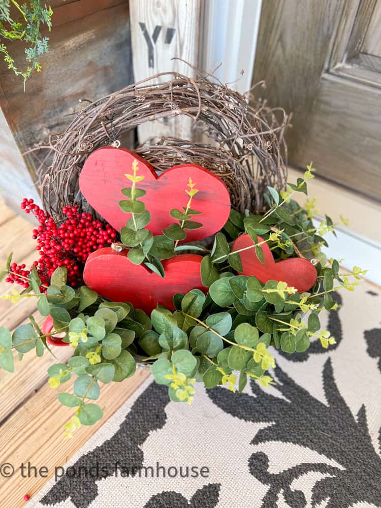 DIY Wooden Heart trio in greenery and with grapevine wreath and berries.  