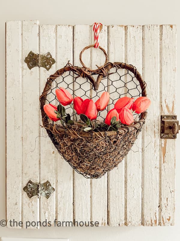 thrifted hanging heart basket planter with red tulips