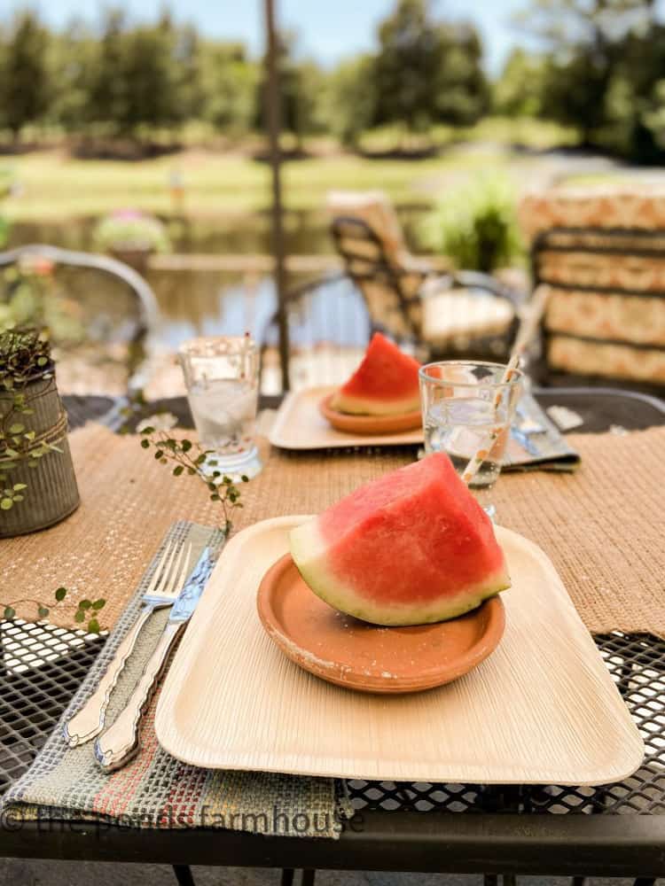 Watermelon served on clay saucers for a summertime outdoor party by the ponds