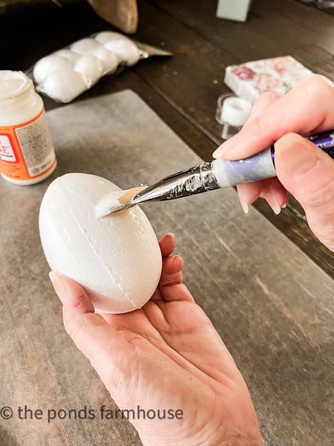 Paint the foam Easter egg with mod podge to begin DIY craft ideas.