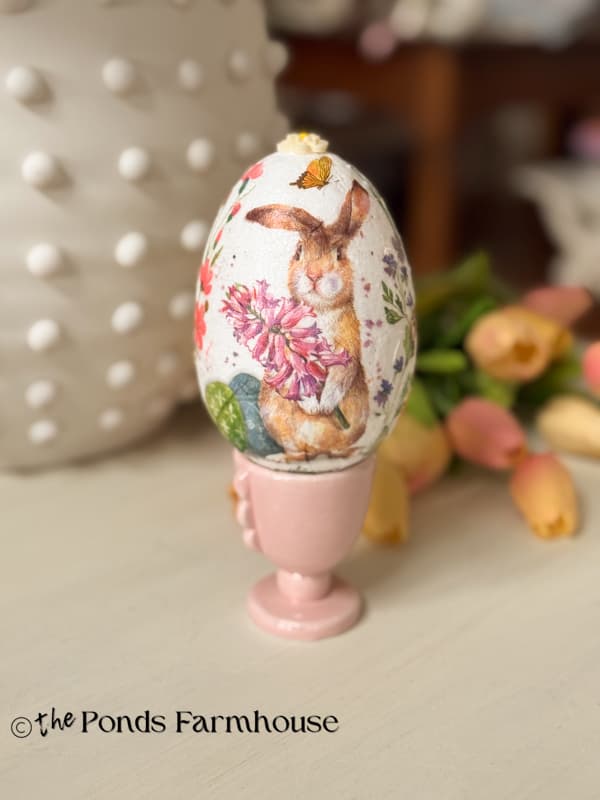 Bunny Decoupage Easter Egg on pink egg holder