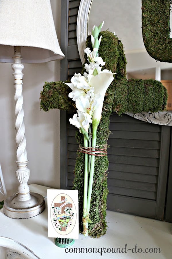 Add a moss-covered cross to your entryway with Easter lilies for a fun Easter HOme Decor Idea.