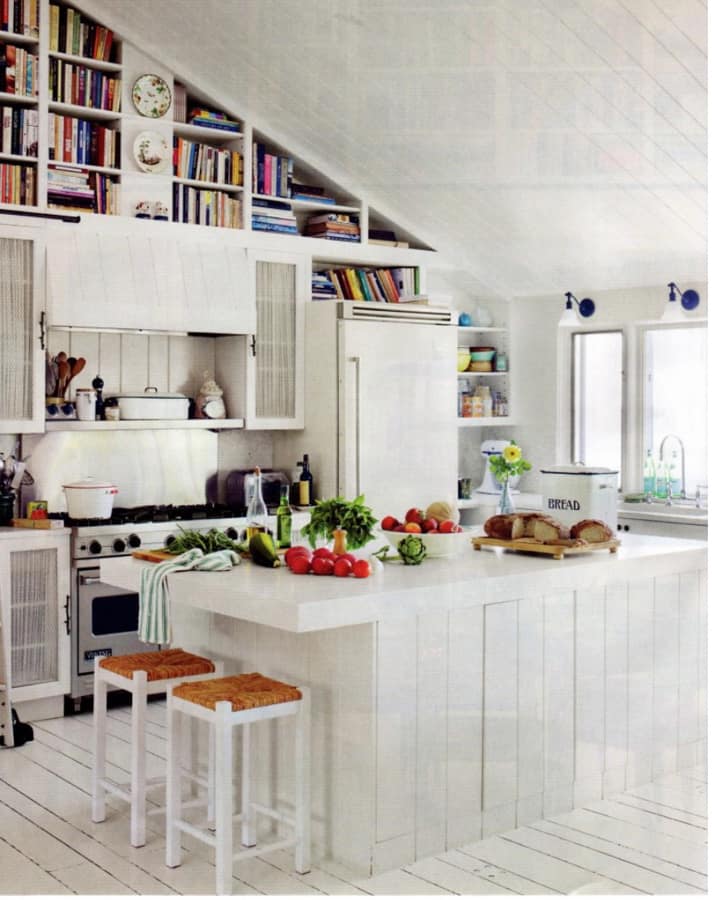 Adding books above the kitchen cabinets helps to fill the normally unused space.  