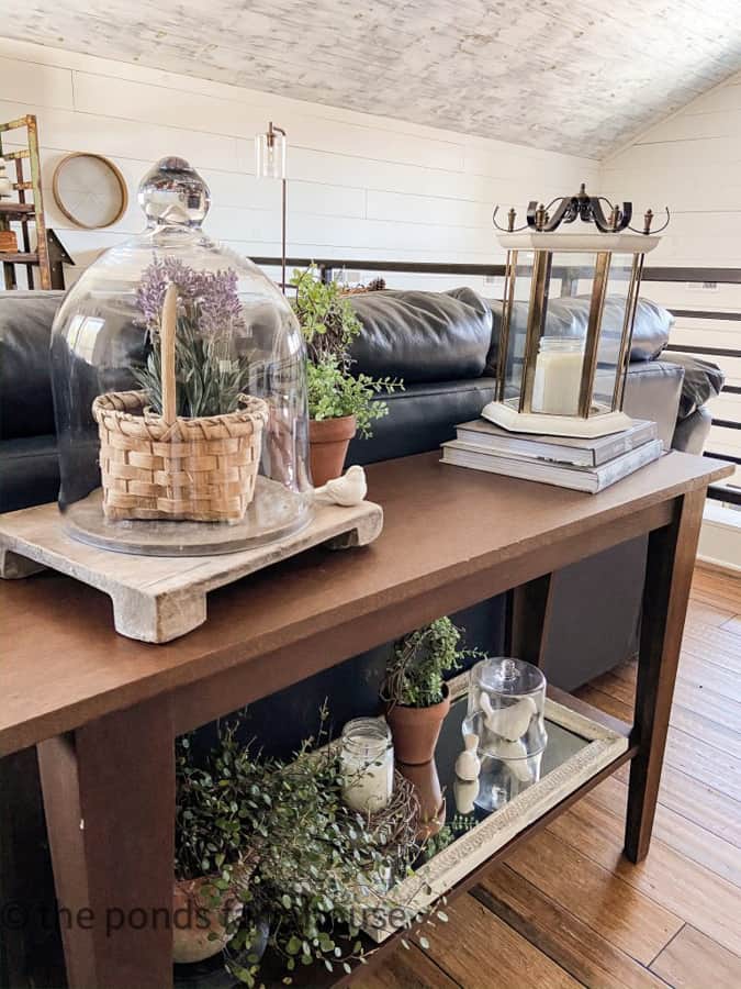 Decorating Sofa Table Ideas with Greenery lanterns, cloches, mirrors and lavender.  