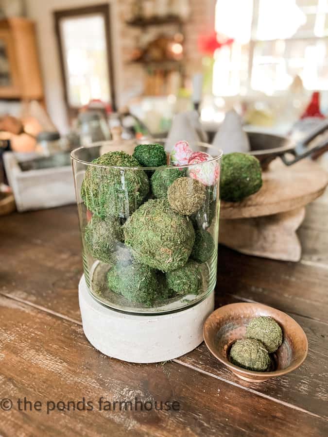 Hurricane Candleholder filled with preserved moss balls.  Vintage Candlesticks Holder used in unique way.