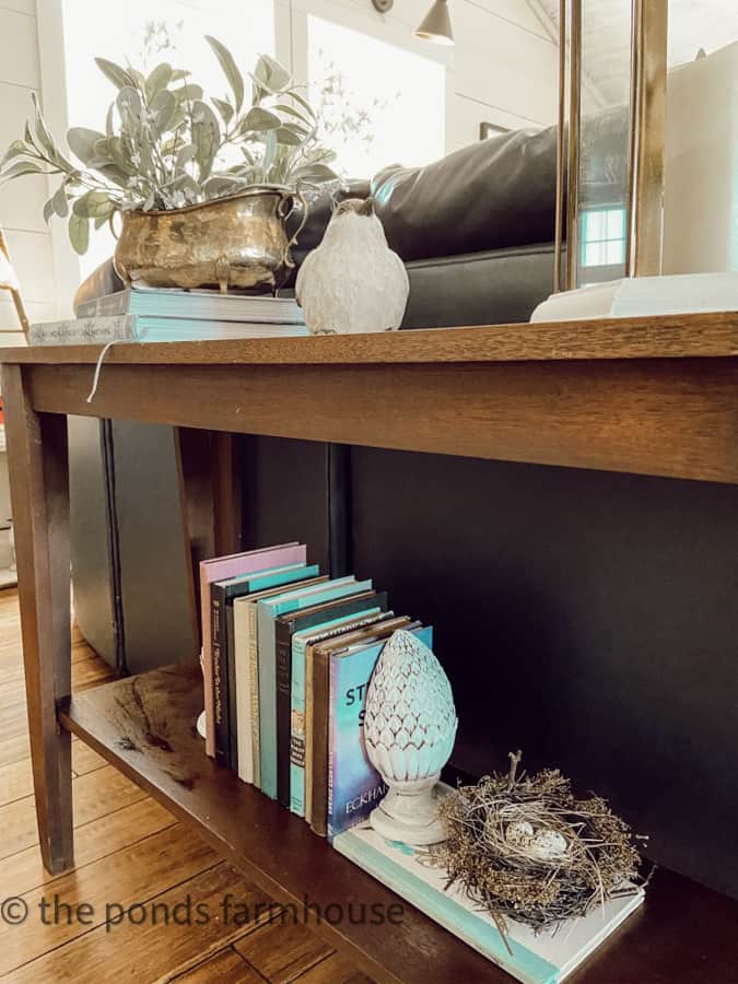 Lower Shelf with books and birds nest for Spring Sofa Table Decorating Ideas