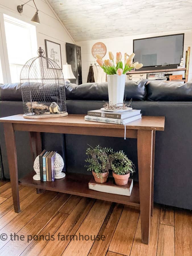 Mix of Birds, greenery and flowers on loft Sofa Table.  Decorating Sofa Table Ideas for Spring.