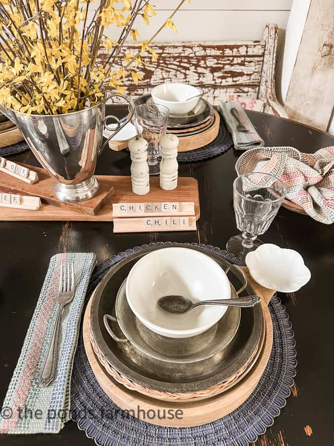 Decorations for Chili Cook-0ff Tablescape includes rustic vintage tin pans, wooden chargers and thrifted decor.