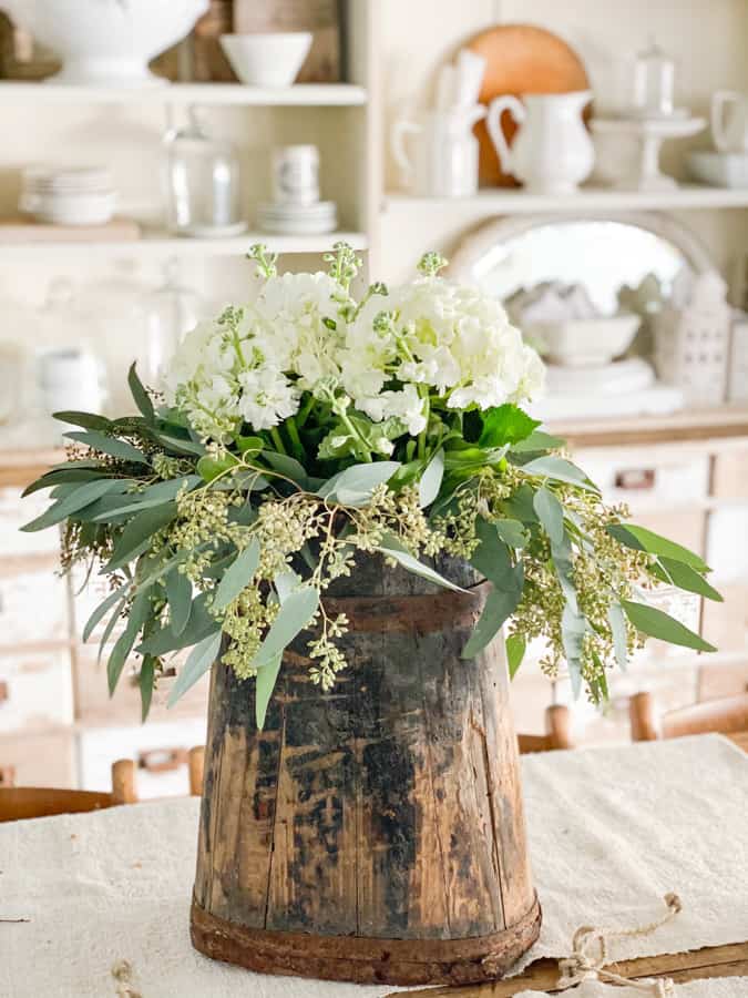 ideas to arrange inexpensive grocery store flowers with unique, vintage vessels for statement-worthy decor.