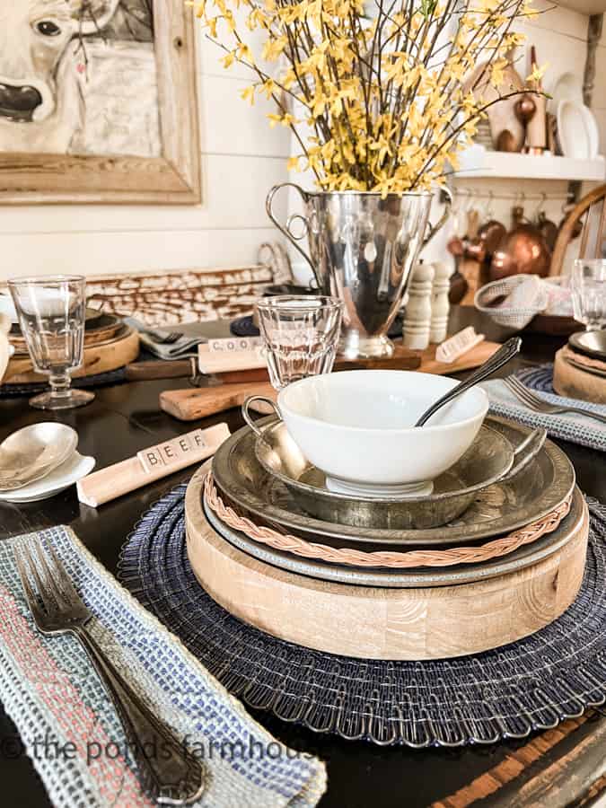 Stacks of rustic chili cook-off decorations fill the farmhouse table for a fun Supper Club theme