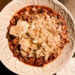 Taco Soup Recipe in white bowl with tortilla chips on top