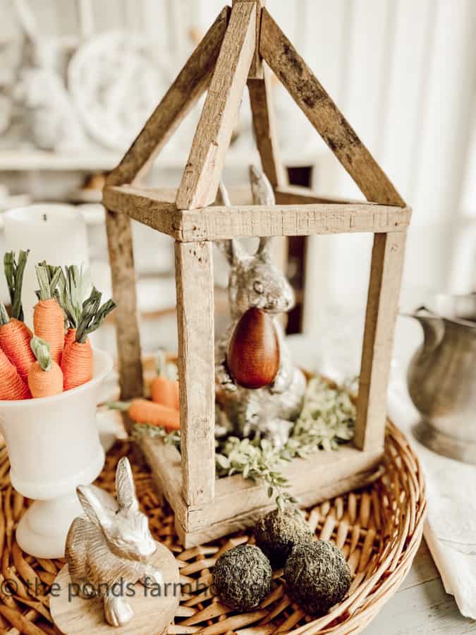 Small Pewter Bunny and preserved moss balls in a woven basket for a centerpiece. Farmhouse Style Centerpiece