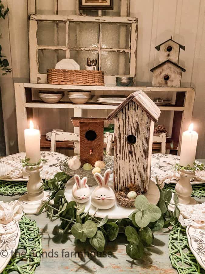 white milk glass cake plate with bird houses and bunny salt and pepper shakers for Easter Centerpiece