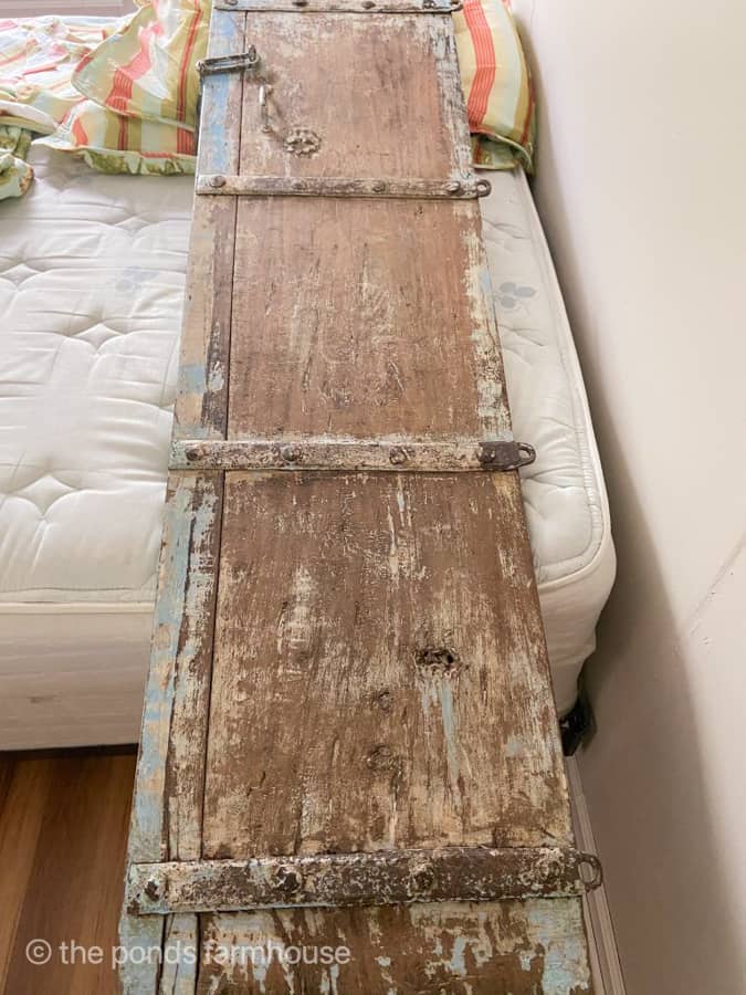 Yard Sale Find Shutter can be repurposed to make a unique space-saving DIY headboard.