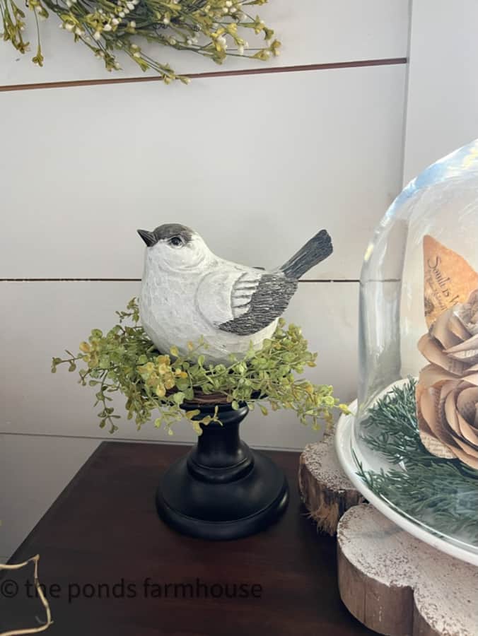 Bird sits on a candle ring instead of a candle - on a thrifted candle holder