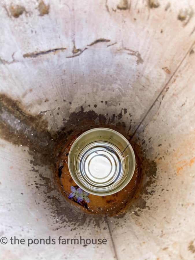 Add tin can to sap bucket to make it water tight.