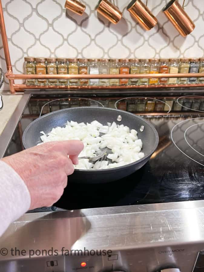 Cook onions in skillet with butter until soft 