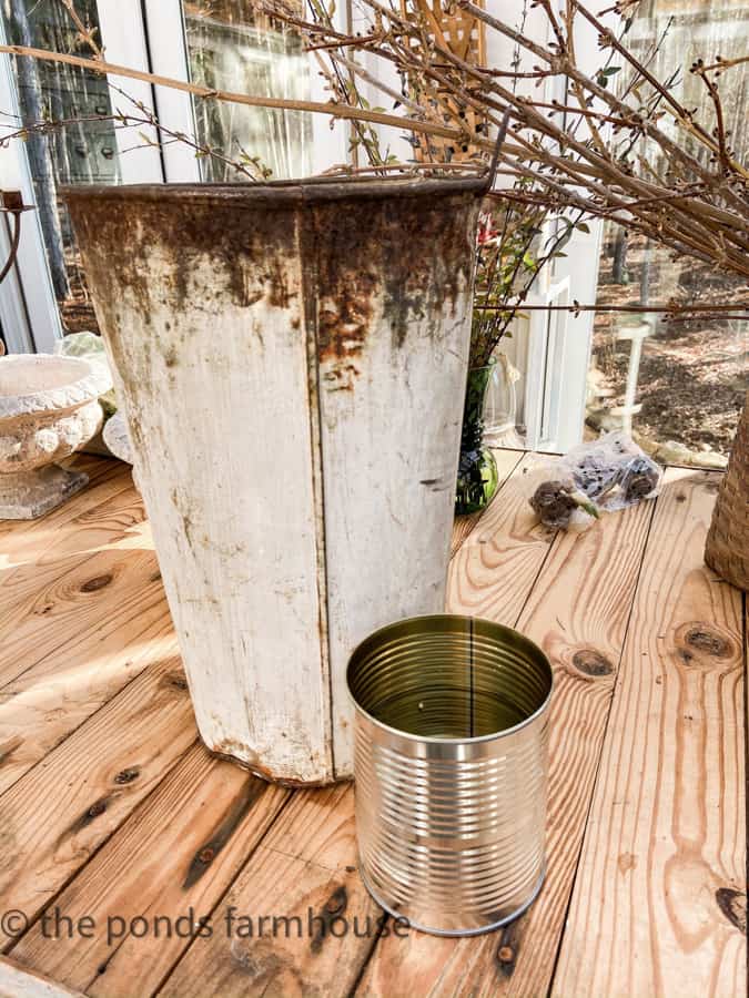 vintage sap bucket and recycled tin can for forced stems containers