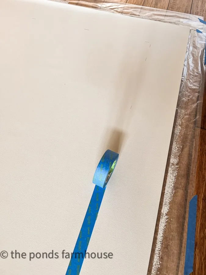 Add painter's tape to vinyl to mask where you don't want paint to adhere.