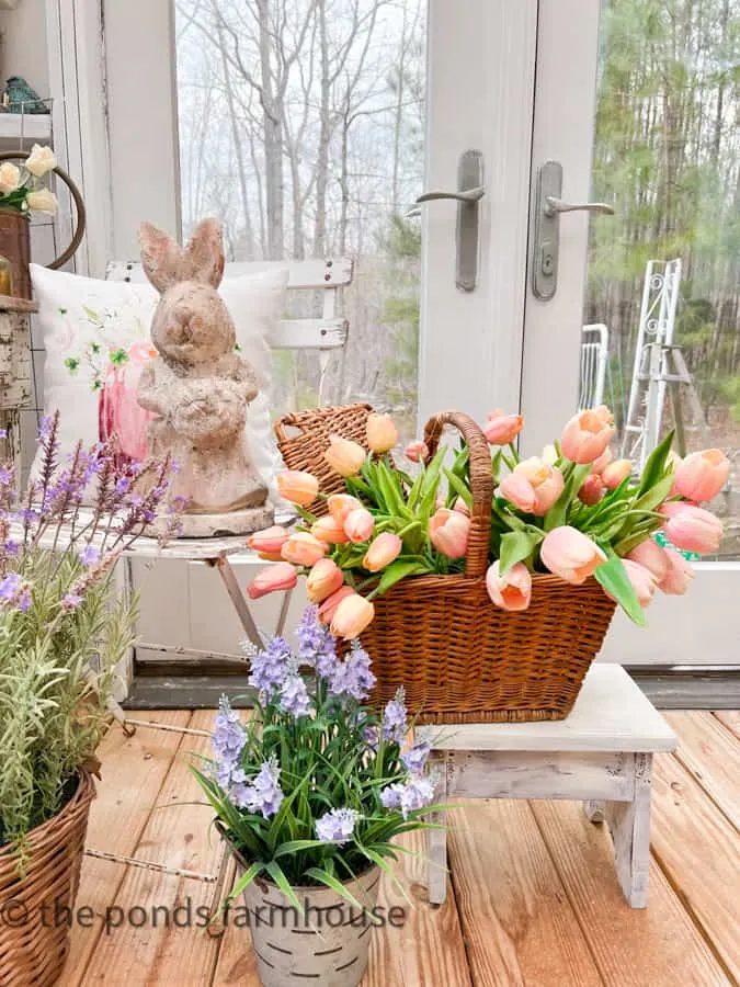 She Shed Interior Ideas with tulips and lavender baskets and concrete bunny with pillow.