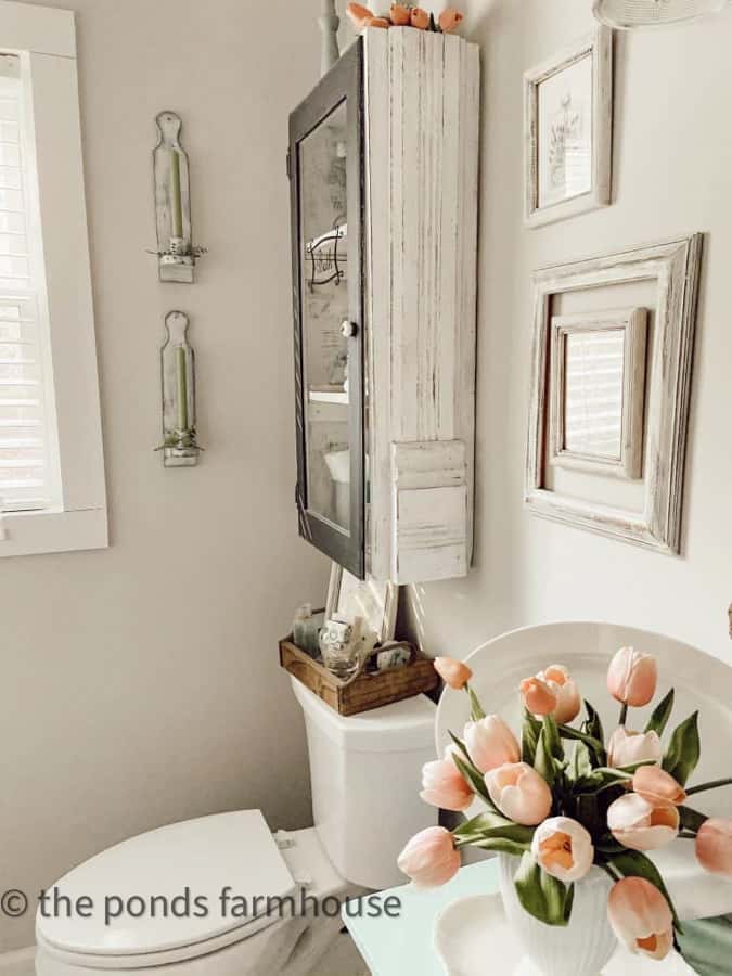 Tulips, repurposed cabinet and wall sconces for bathroom tips for Spring decorating.