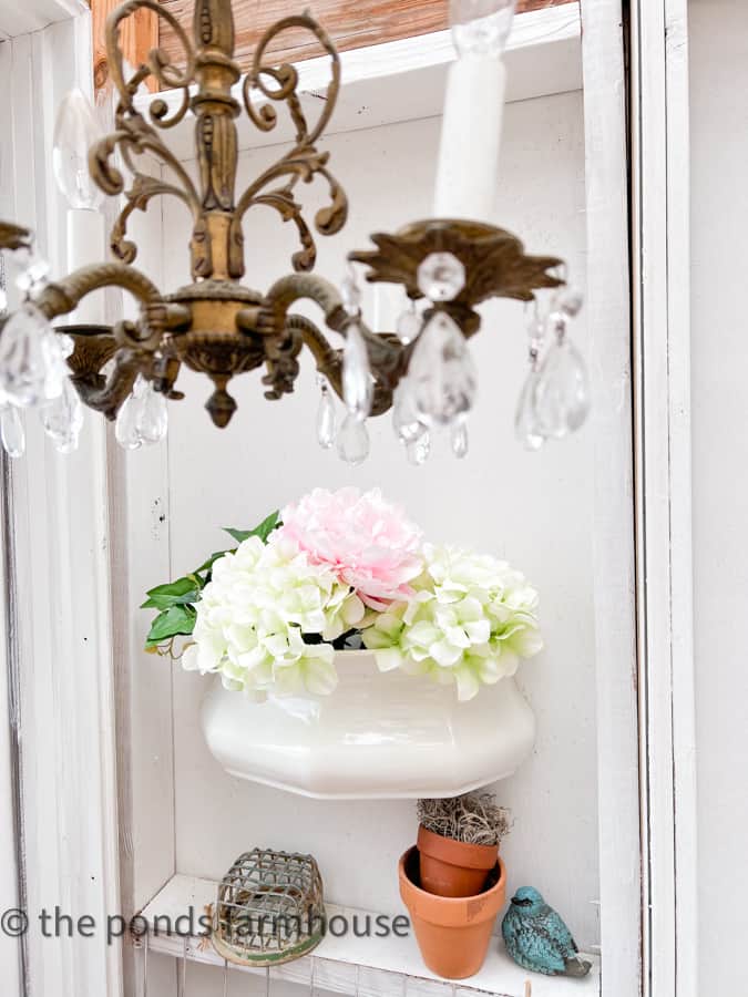 Ironstone wall planter with hydrangeas and with vintage chandelier