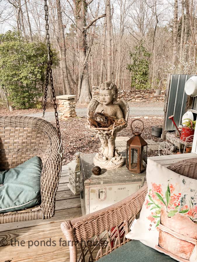 Ideas to Decorate for Easter by using concrete statuary angel with bird nest and floral pillow for Easter Outdoor Decor.  